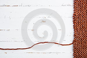 Unravelling knitted fabric on white background