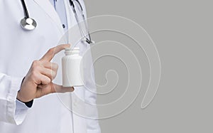 Unrcognizable male doctor holding blank box with pills in hand