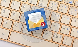 Unread Email Icon on dice with keyboard in background