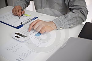 Unrecognisable businessman, accountant, banker counting money at the workplace, white background