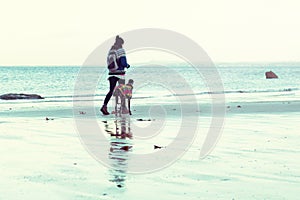 Unrecognisable hipster girl walking her dog, Greyhound, on the beach.