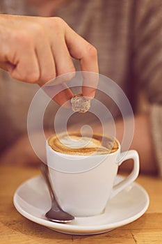 Unrecognisable man drinking coffee and having breakfast.