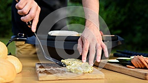 Unrecognisable man using electric grill. Garden grill party, summer barbecue