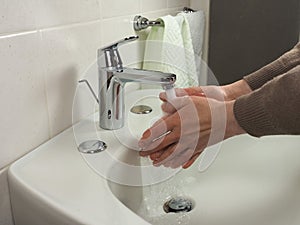 Unrecognisable man washing hands