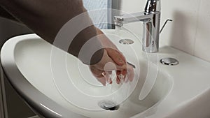 Unrecognisable man washing hands