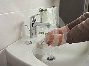 Unrecognisable man washing hands