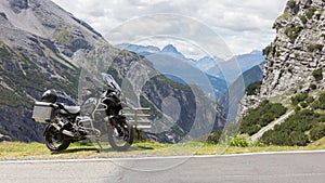 Unrecognisable motorcycle and driver in the Alps