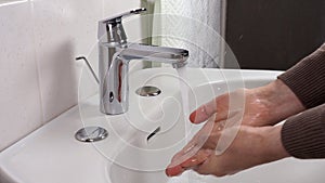 Unrecognisable person washing hands