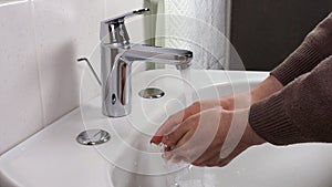 Unrecognisable person washing hands