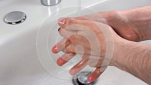 Unrecognisable person washing hands