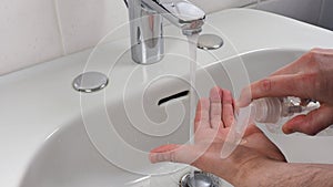 Unrecognisable person washing hands