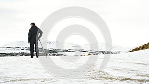 Unrecognisable senior man enjoying view , snow covered landscape, Edinburgh