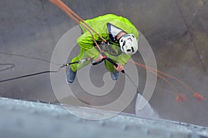 Unrecognisable window cleaner works on high rise building