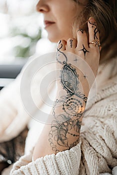 Unrecognisable young lady with painted hand sacral mehendi