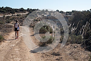 Unrecognised woman hiking outdoors. Healthy lifestyle. People exercising outdoors