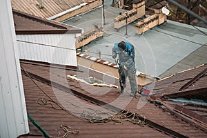 Unrecognised worker on modern roof, construction industry