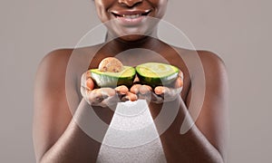 Unrecognizable African American Female Holding Two Avocado Halves In Hands,