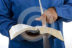 Unrecognizable African American man reading the Bible.