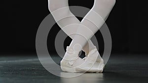 Unrecognizable ballerina dancer female legs close-up details dancing ballet movements unknown girl wearing pointe shoes