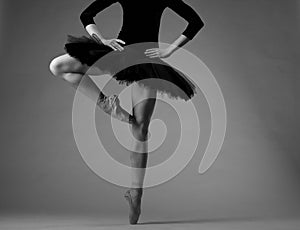 Unrecognizable ballerina in studio, black tutu outfit. classical ballet art. grayscale image