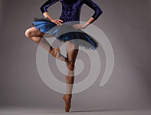 Unrecognizable ballerina in studio, blue tutu. classical ballet.