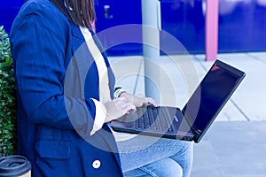 Unrecognizable beautiful Caucasian businesswoman using a laptop