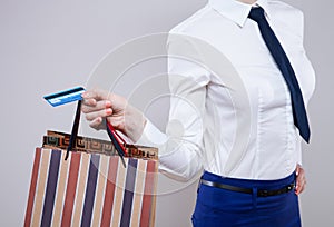 Unrecognizable business woman holding shopping bags and plastic