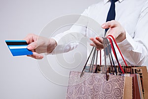Unrecognizable business woman holding shopping bags and plastic