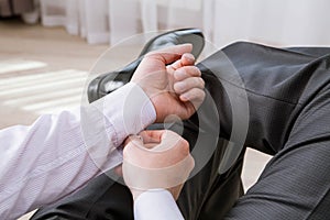 Unrecognizable businessman clasping a cuff