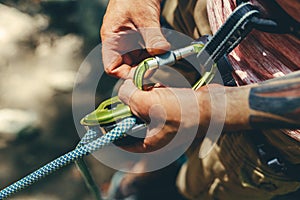 Unrecognizable Climber Man Wearing In Safety Harness Check Climbing Equipment Outdoor