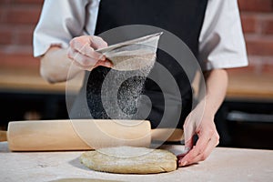 Unrecognizable cook making dough