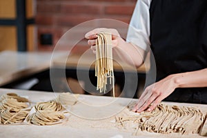 Unrecognizable cook making pasta