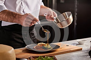 Unrecognizable cook preparing food, meal, in kitchen, chef cooking, Chef decorating dish, closeup