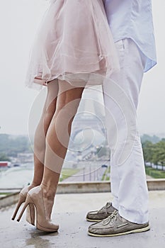 Unrecognizable couple in front of the Eiffel tower in Paris