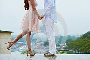 Unrecognizable couple in front of the Eiffel tower in Paris