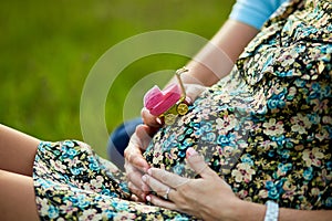 Unrecognizable couple, future parents, pregnant young woman and a man touching belly