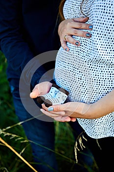 Unrecognizable couple, future parents, pregnant young woman and a man touching belly