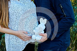 Unrecognizable couple, future parents, pregnant young woman and a man touching belly