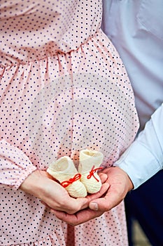 Unrecognizable couple, future parents, pregnant young woman and a man touching belly