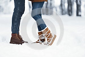 Unrecognizable Couple Standing In Snow On Winter Forest Background