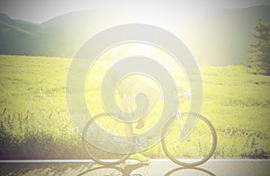 unrecognizable cyclist with racing bike on the road in backlight ideal as a background for sports concept