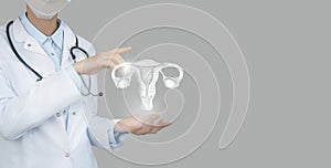 Unrecognizable doctor holding highlighted handrawn Uterus in hands. Medical illustration, template, science mockup photo
