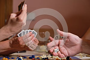 Unrecognizable family hands playing board games