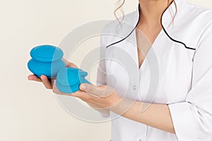 Unrecognizable female medical therapist holding blue Chinese bubble cups for vacuum anti cellulite massage. Copy space