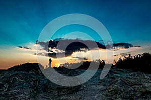 Unrecognizable female silhouette at sunset