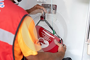 Unrecognizable first aid worker holding a defibrillator bag