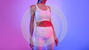 Unrecognizable Fitness Lady With Perfect Body Standing, Neon Background