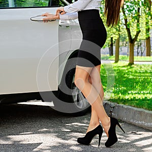 Unrecognizable girl opens the door of her car