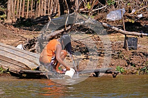 Unrecognizable girl washing her hair along the Rio Parguay river, Pantanal, Corumba, Mato Grosso Do Sul, Brazil