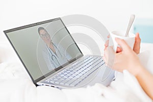 Unrecognizable girl watching a video with medical advice on a laptop. A woman conducts an online conversation with a